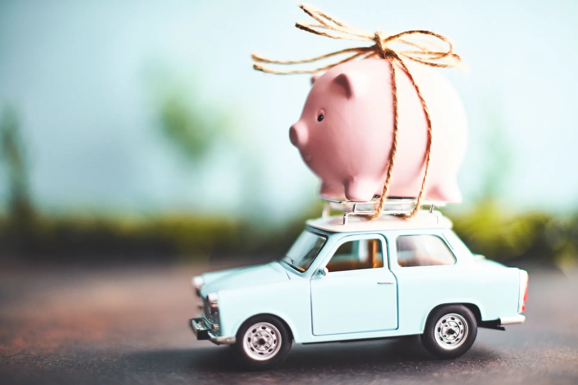 Piggy bank on the roof of a car